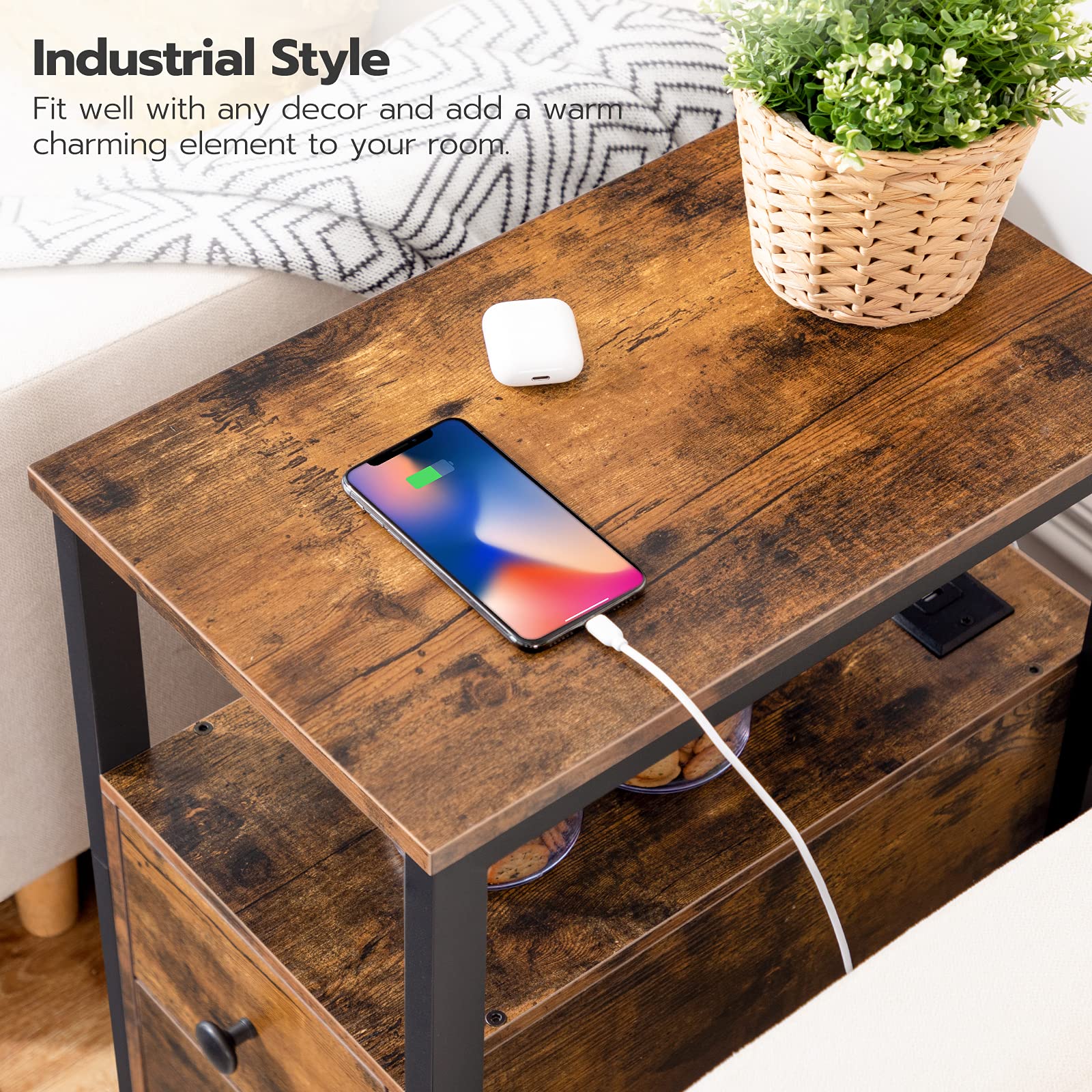Wooden side table with smartphone, mouse, and plant in a living room setting.