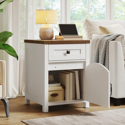White nightstand with wooden top in a room with a sofa and lamp.