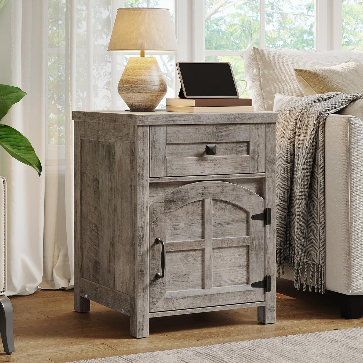 Wooden nightstand with lamp and tablet in a living room setting