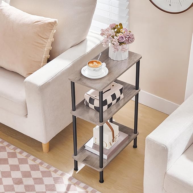 Three-tier side table with a cup of coffee, flowers, and books in a living room setting.