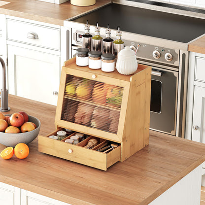 Wooden kitchen storage unit with spices and a bowl of fruit on a kitchen counter.