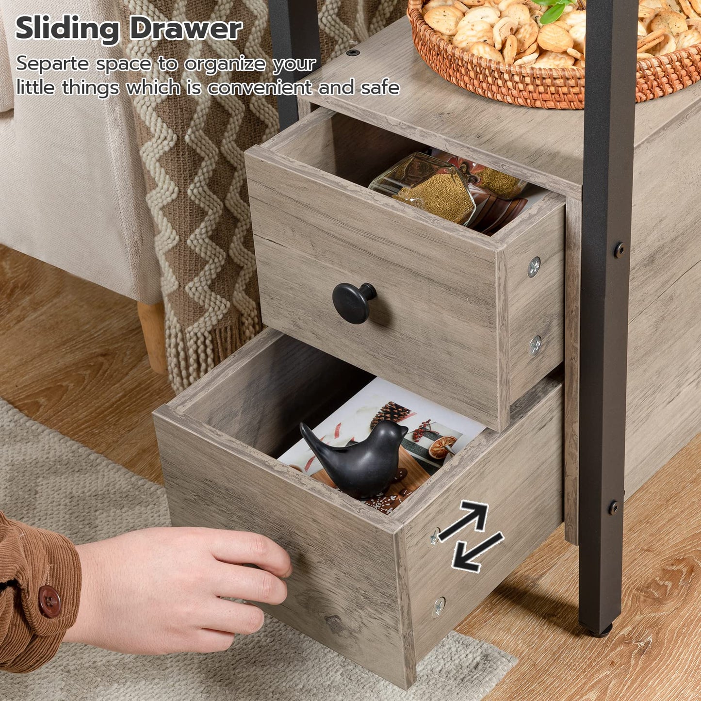 Wooden sliding drawer with a hand opening it, containing small items.