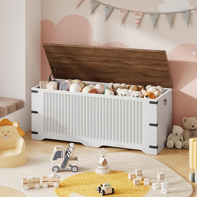 White toy storage box filled with toys in a child's room with pink walls and decorative flags.