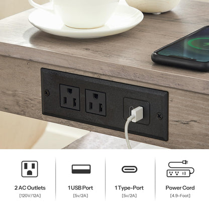 Power outlet panel with multiple ports on a wooden surface with a cup and phone.