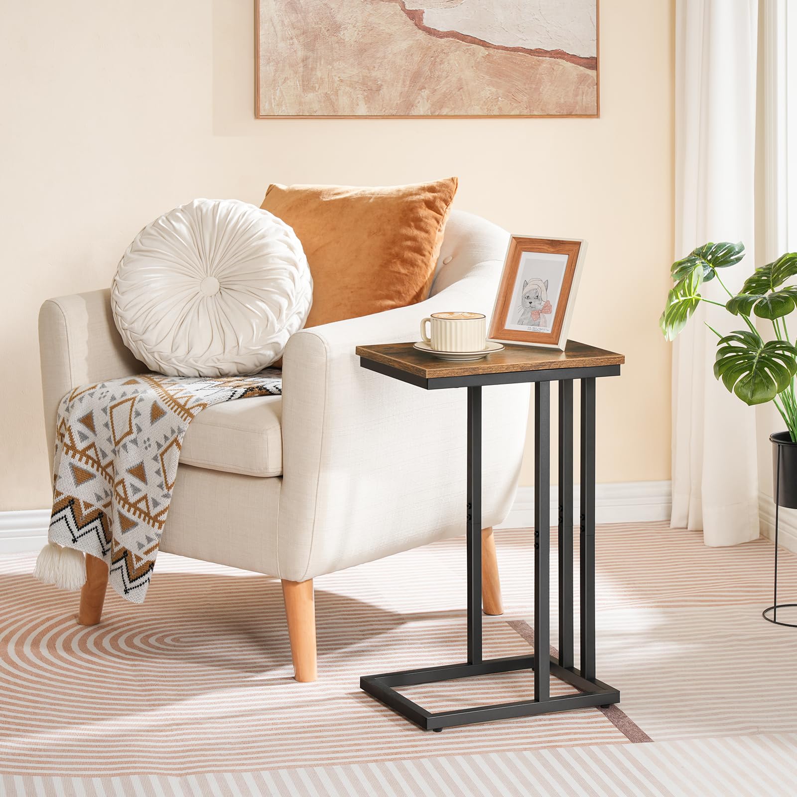 Small wooden side table next to a white armchair with cushions in a living room setting.