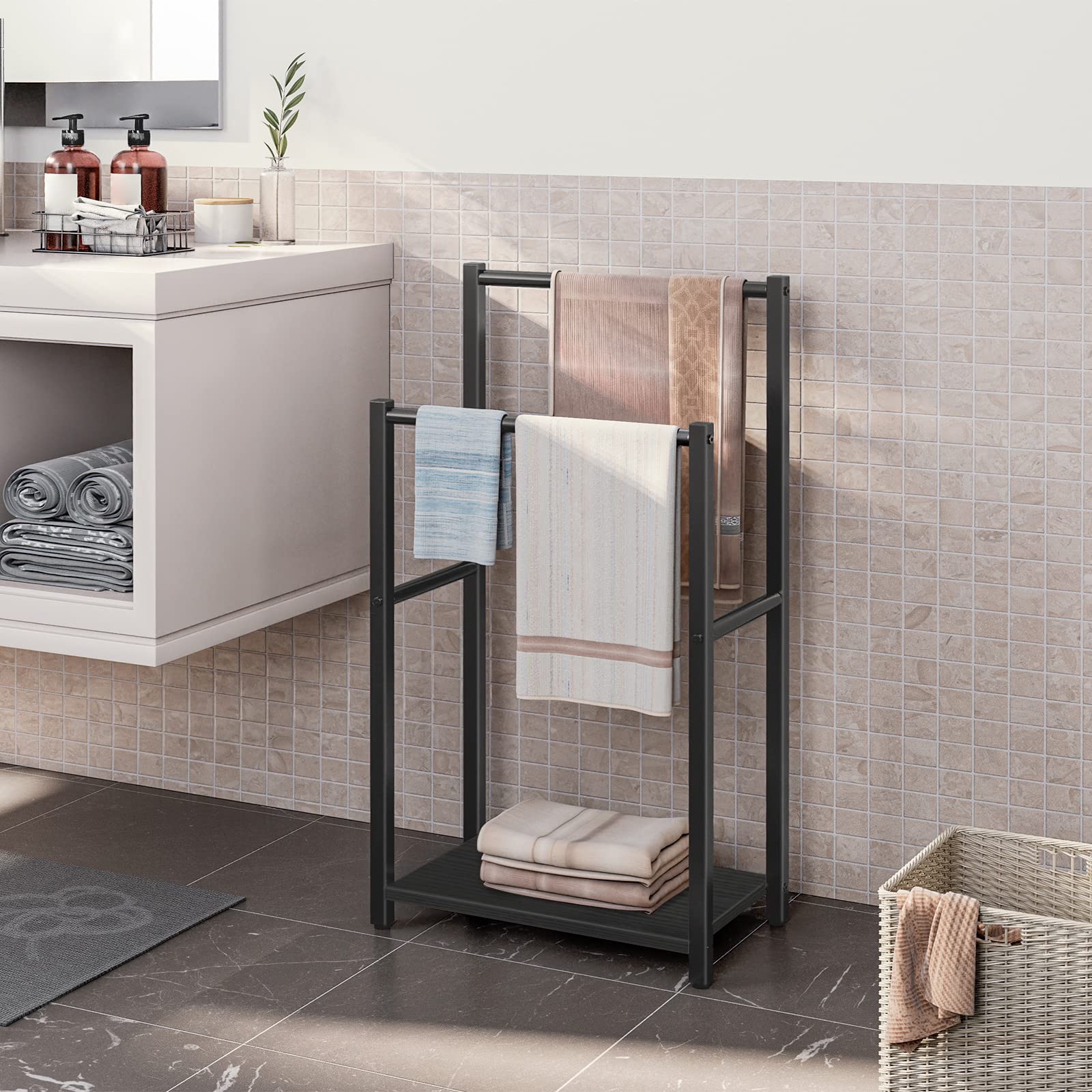 Bathroom scene with a towel rack holding folded towels against a tiled wall.