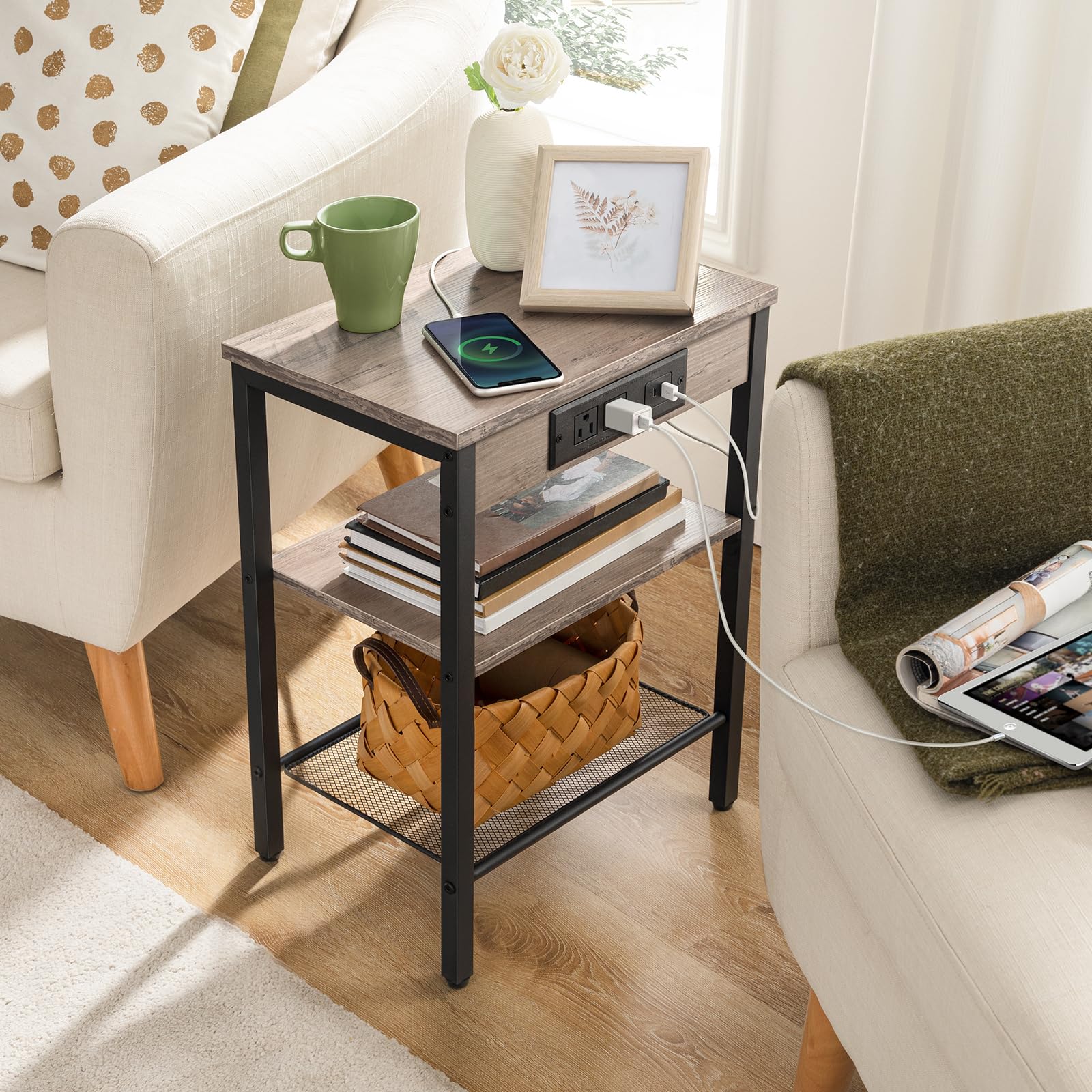 Small wooden side table with charging ports in a living room setting.