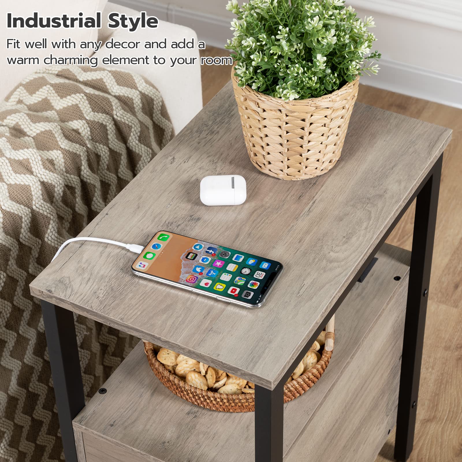 Small wooden table with a smartphone, wireless charger, and plant in a room setting.