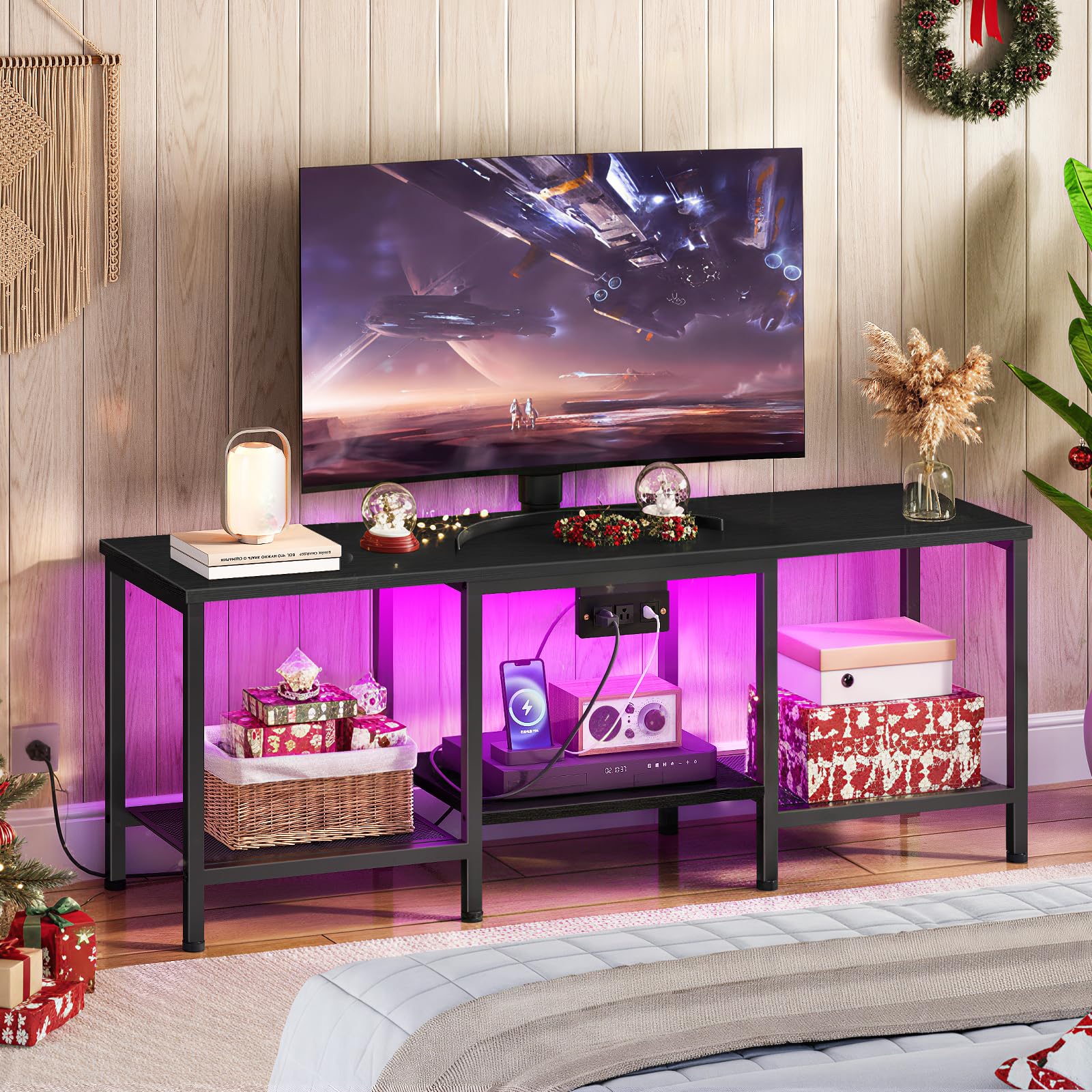 Black TV stand with colorful LED lighting in a living room setting.