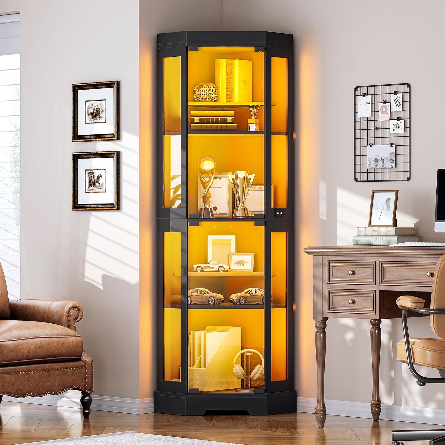 Tall glass display cabinet with yellow interior lighting in a room with a desk and chair.