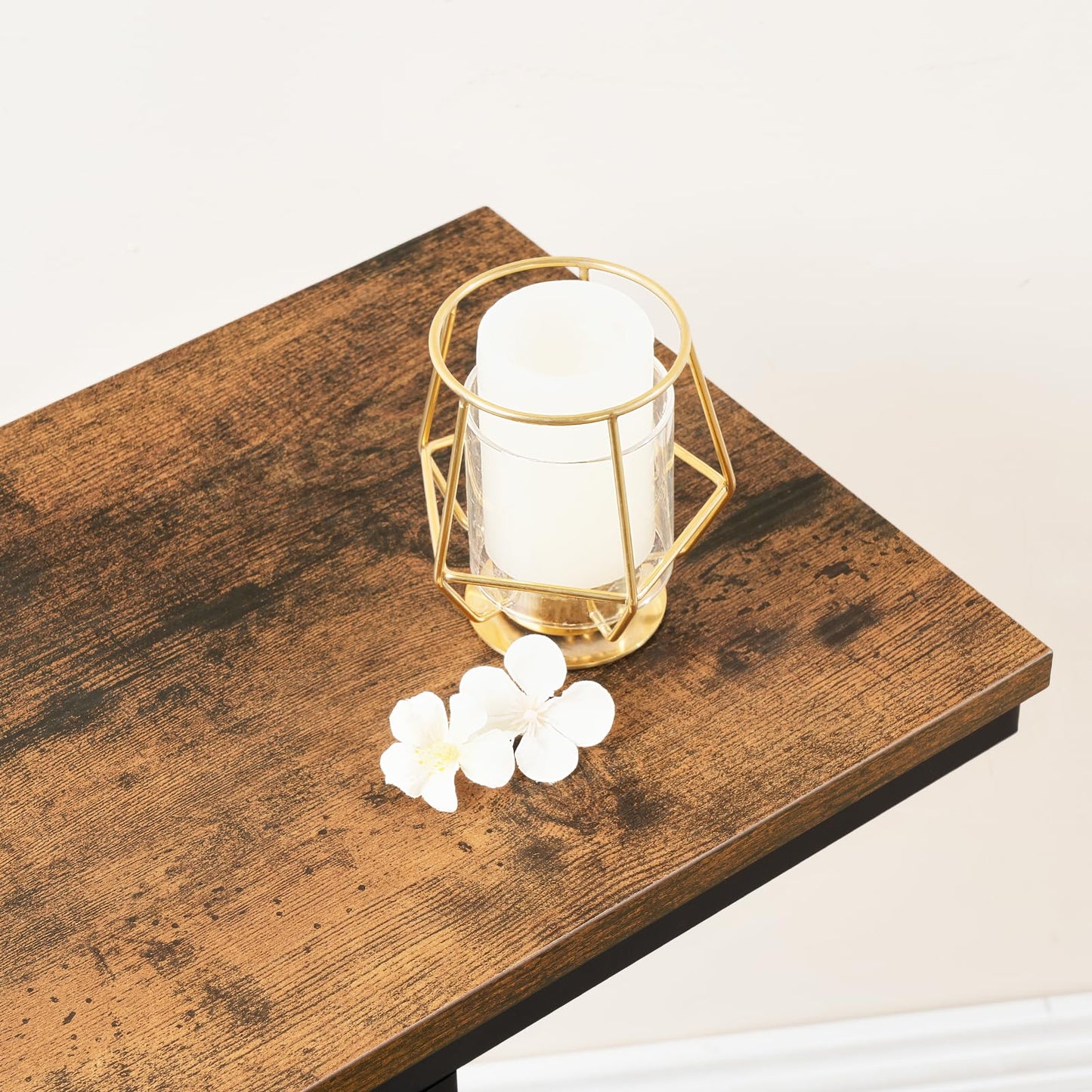 Decorative candle holder with flowers on a wooden surface