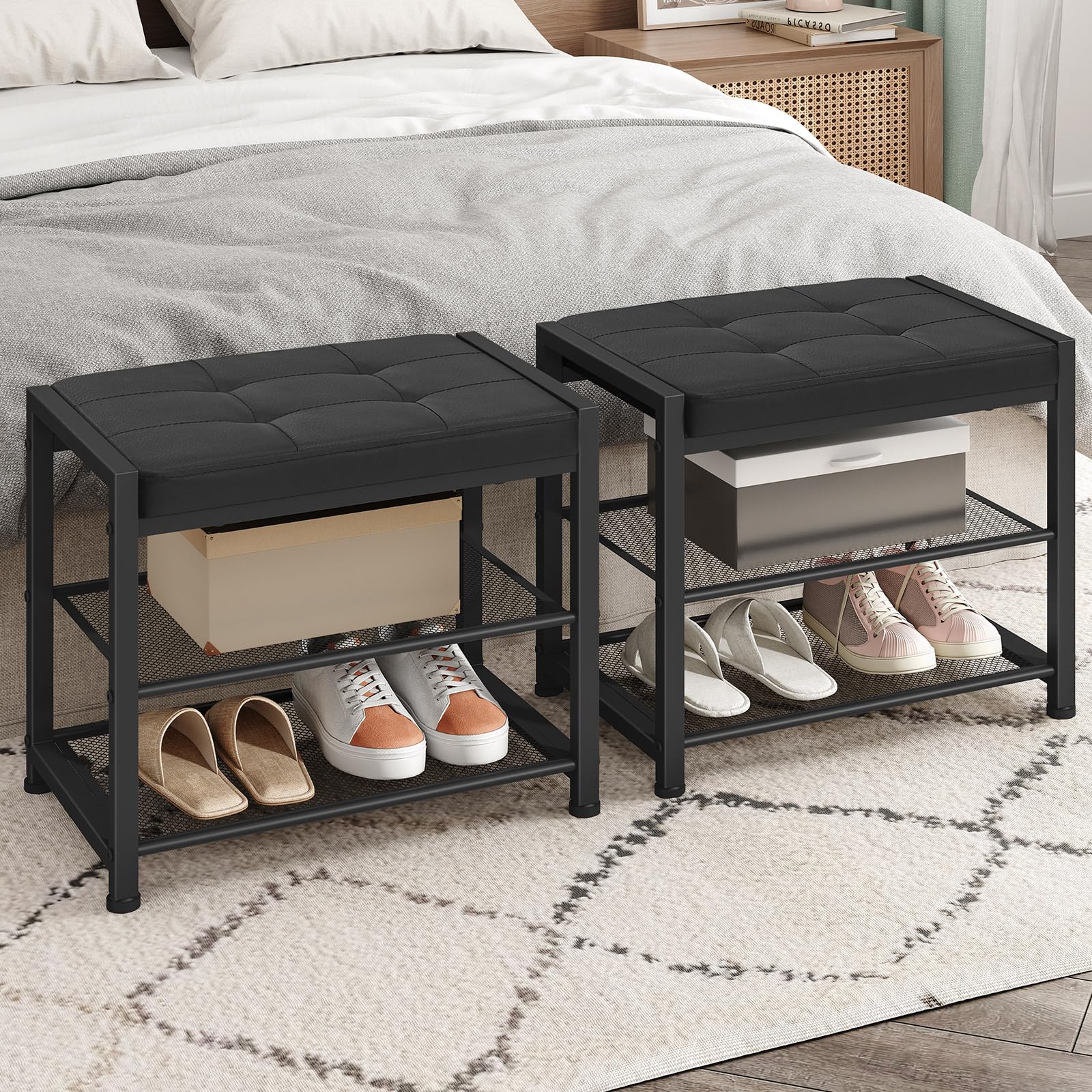 Two black shoe storage ottomans with shoes on a bed in a bedroom setting.