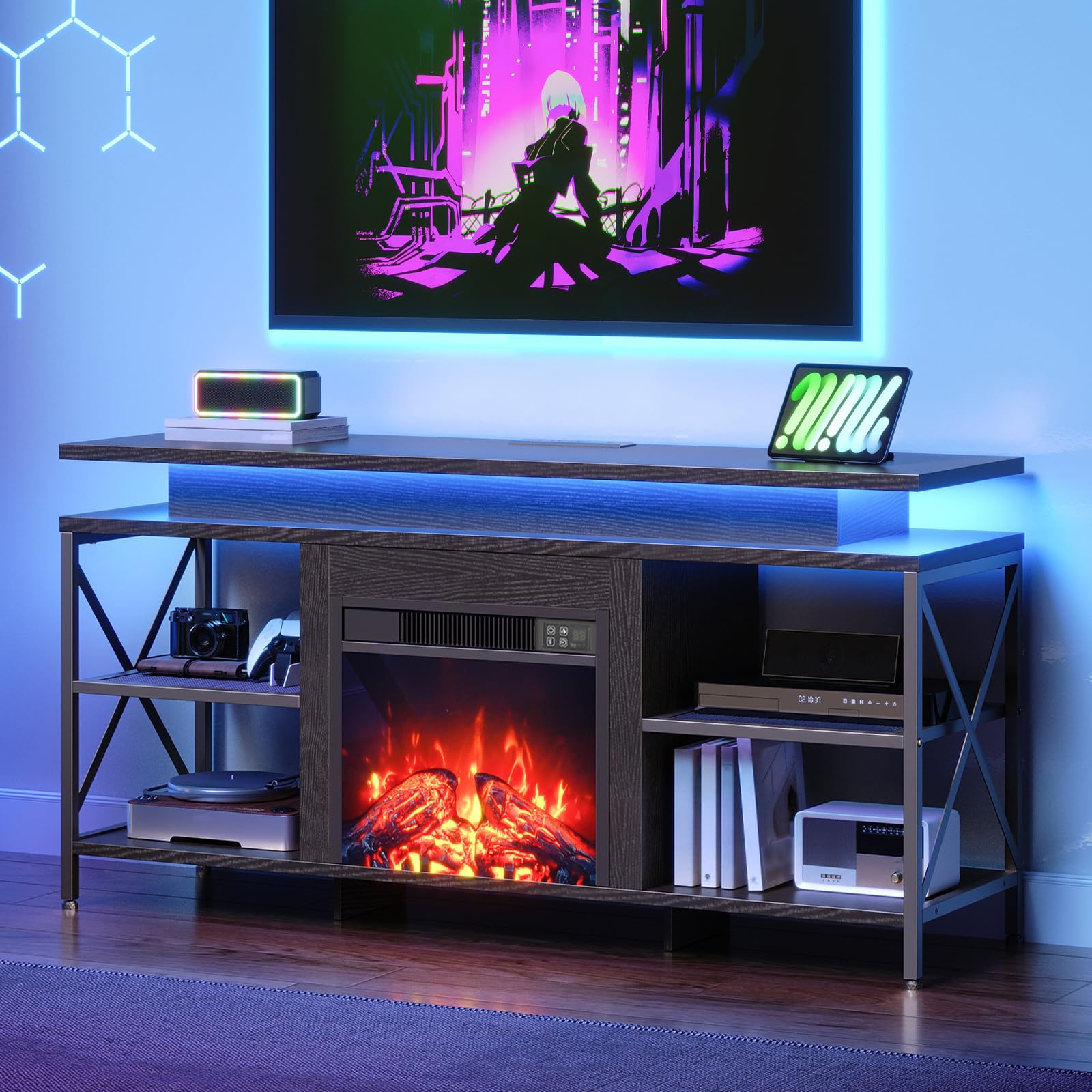 Modern entertainment console with electric fireplace, TV, and gaming setup in a room with blue lighting.