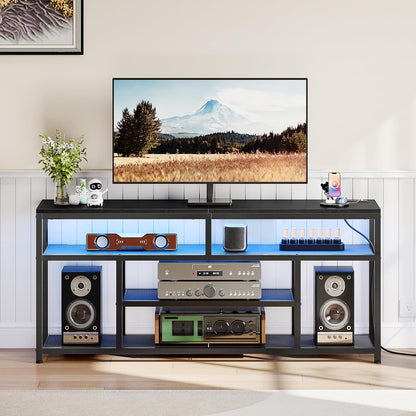 Modern entertainment console with TV, speakers, and decorative items in a living room setting.