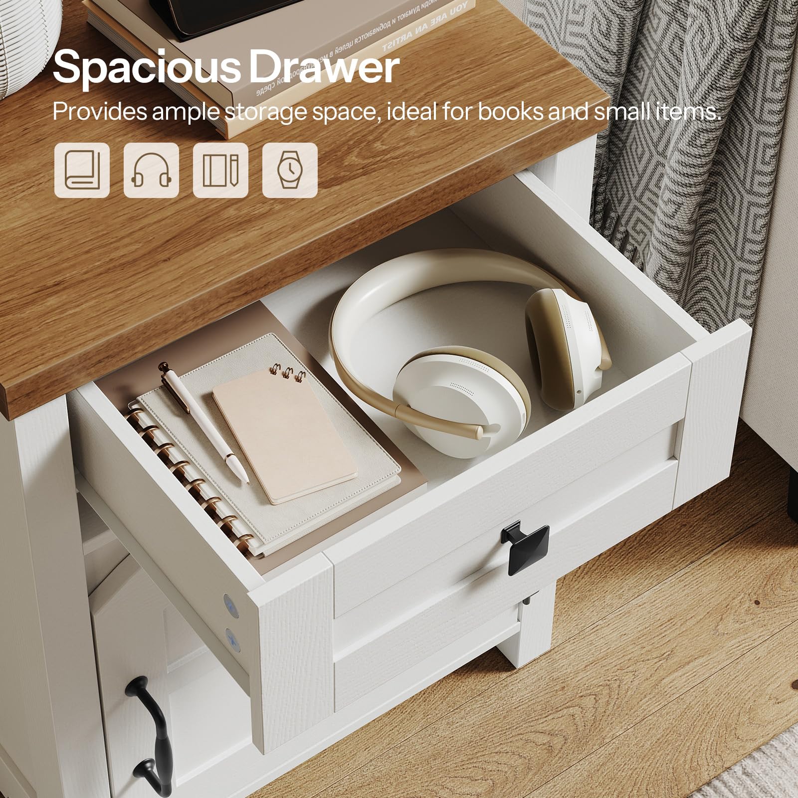 Open drawer with books, headphones, and a notebook on a wooden desk.