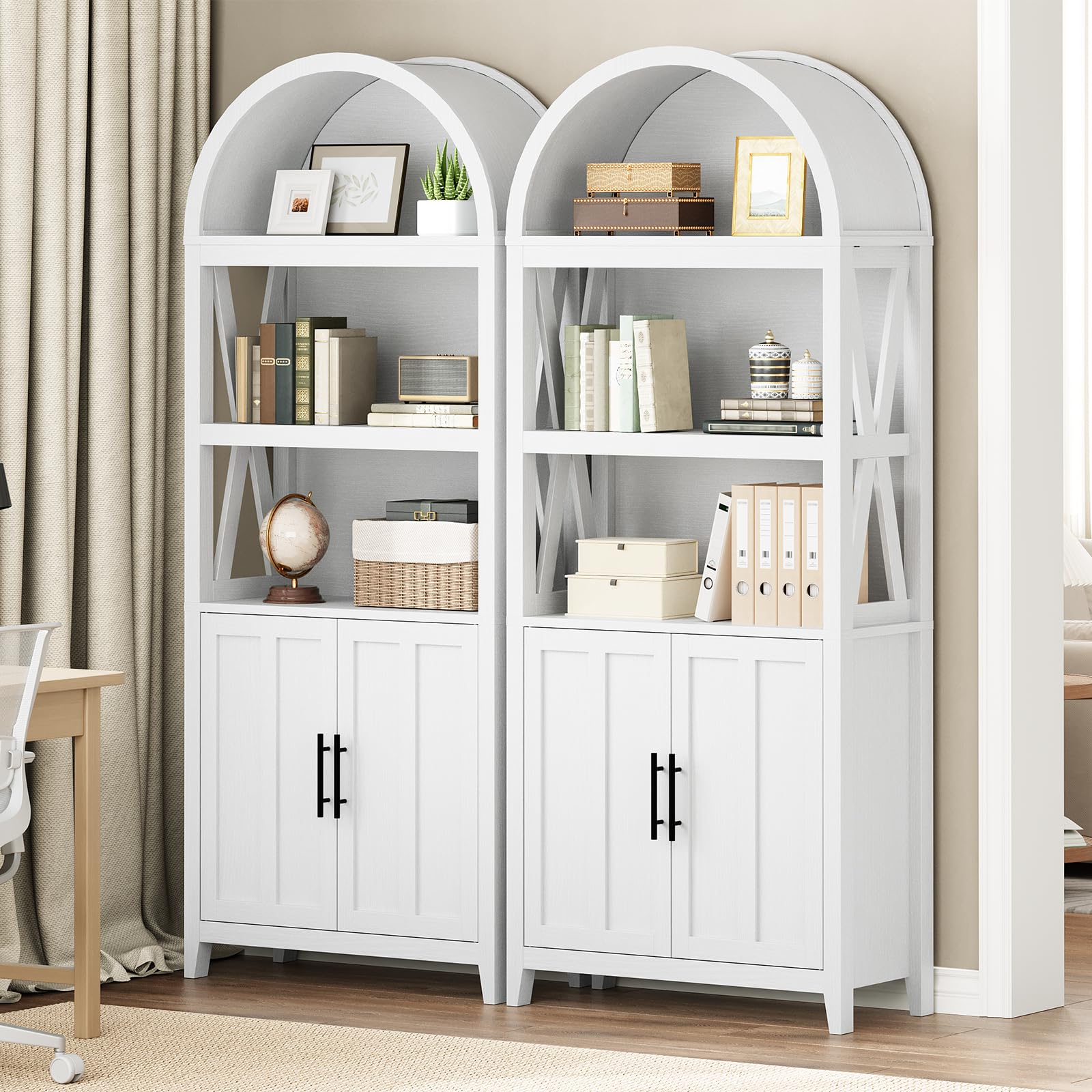 White bookshelves with arched top and cabinet doors in a room setting.