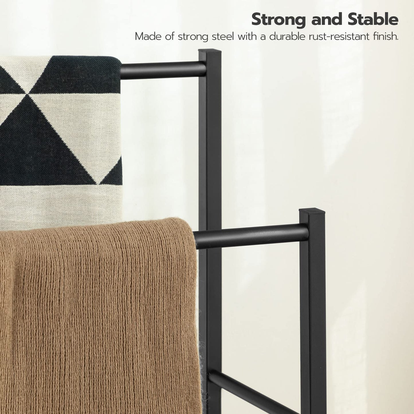 Black metal towel rack holding a patterned towel and a brown towel on a light background with text about strength and stability.