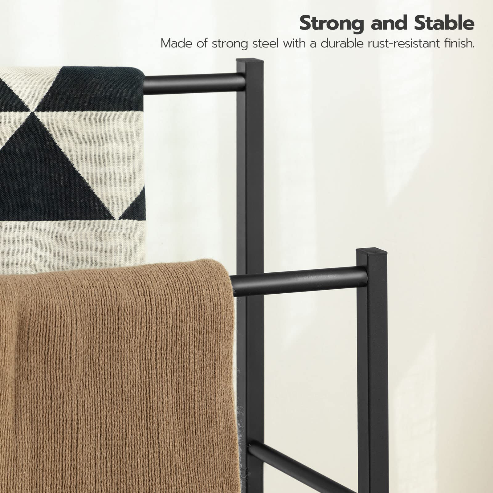 Black metal towel rack holding a patterned towel and a brown towel on a light background with text about strength and stability.