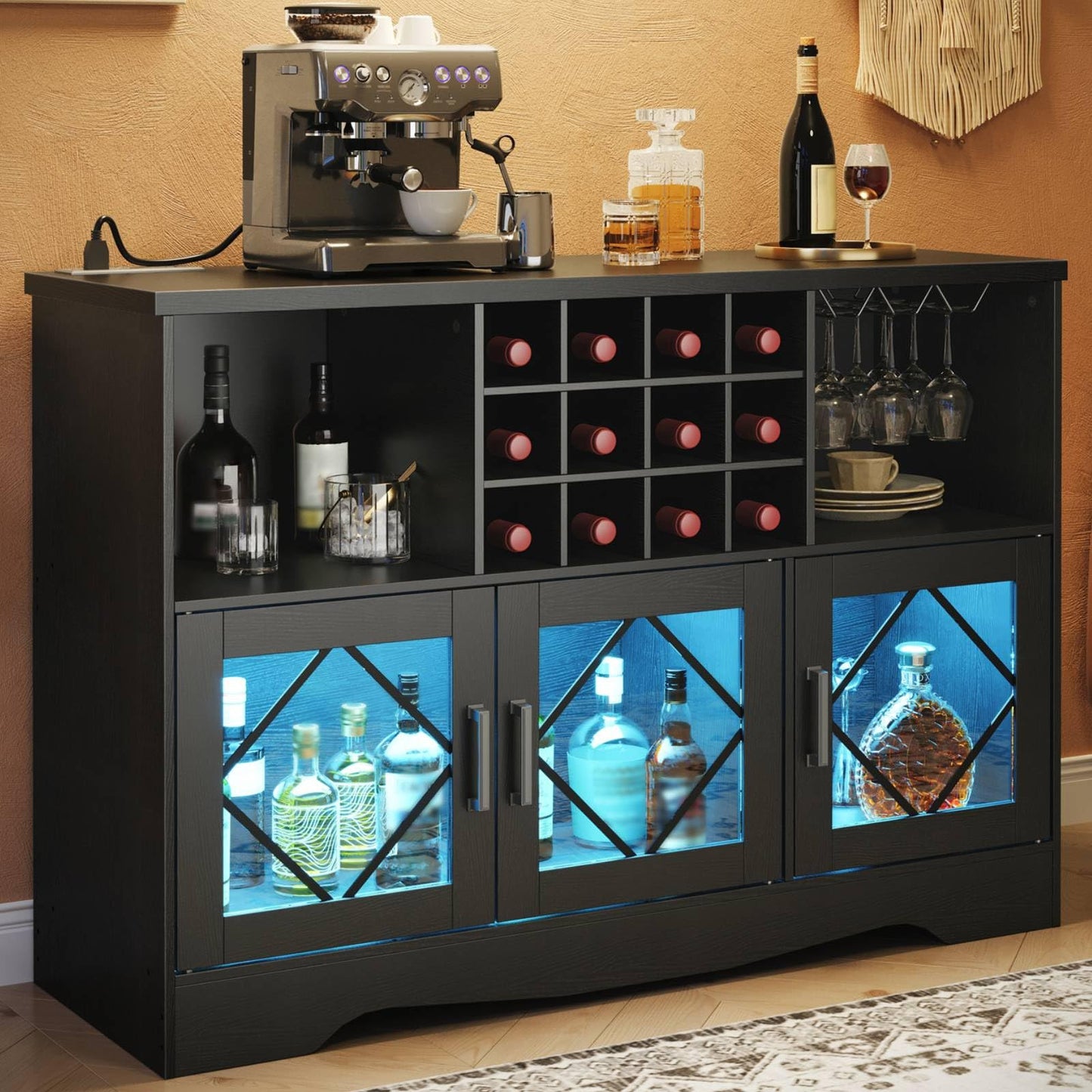 Black entertainment console with wine bottles and glasses against a beige wall.