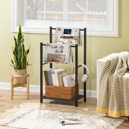 Living room with a magazine rack, plant, and books on a wooden floor.