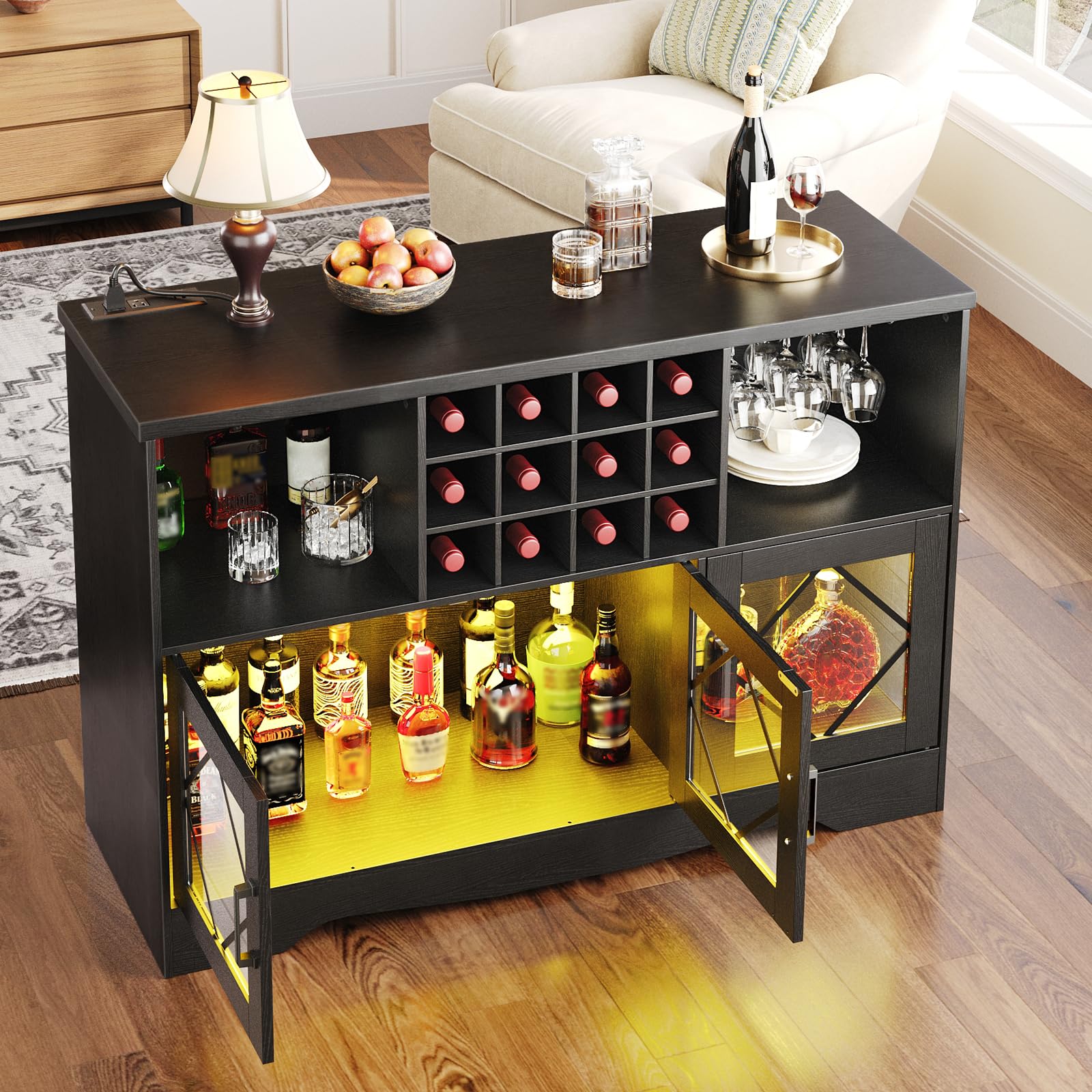 Black bar cart with open doors displaying bottles in a living room setting.