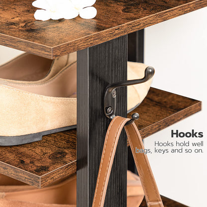 Wooden shoe rack with hooks holding shoes and a strap.