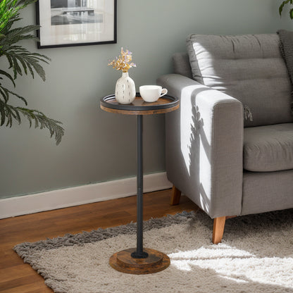 Small round wooden side table with a black metal stand next to a gray sofa in a living room.