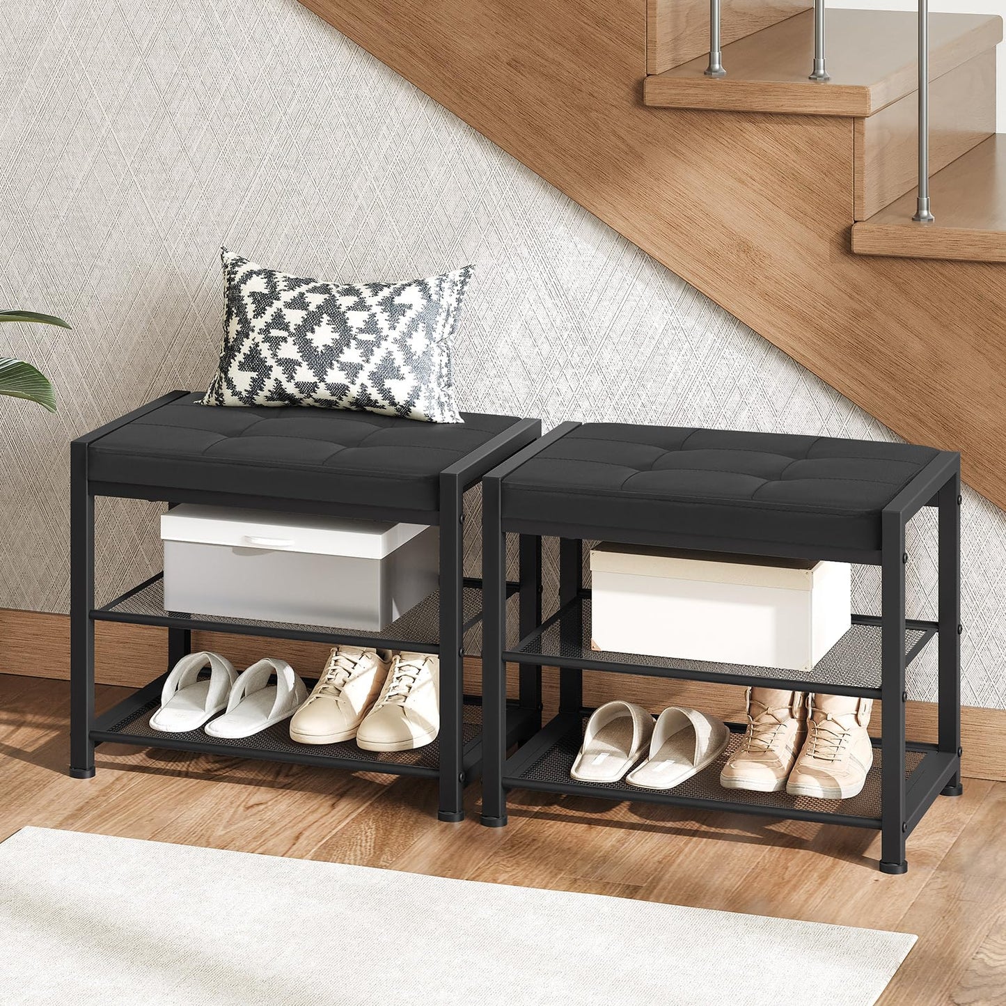 Two black shoe racks with shoes and a box on a wooden floor.