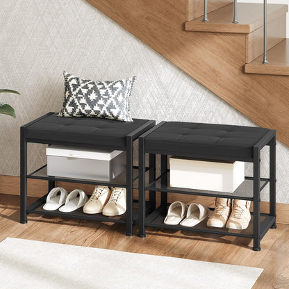 Two black shoe racks with shoes and a box on a wooden floor.