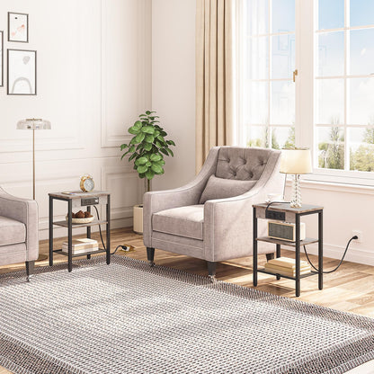 Living room with gray armchair, side tables, and a large window.