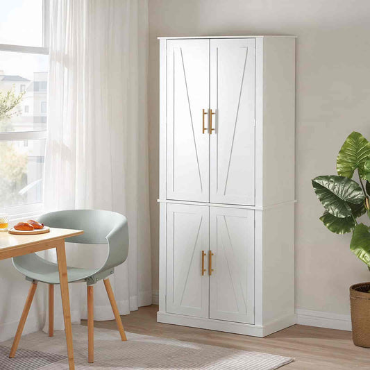 White cabinet with gold handles in a room with a table and chair, and a plant.