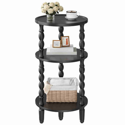 Black three-tiered round table with decorative items on a white background