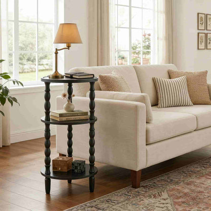Beige sofa with decorative pillows in a living room setting with a side table and lamp.