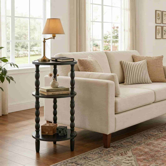 Beige sofa with decorative pillows in a living room setting with a side table and lamp.