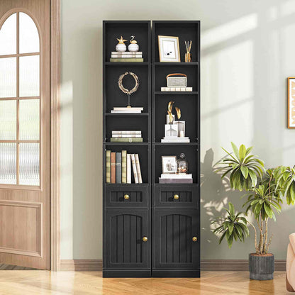 Black bookshelf with decorative items in a room with plants and a wooden door.