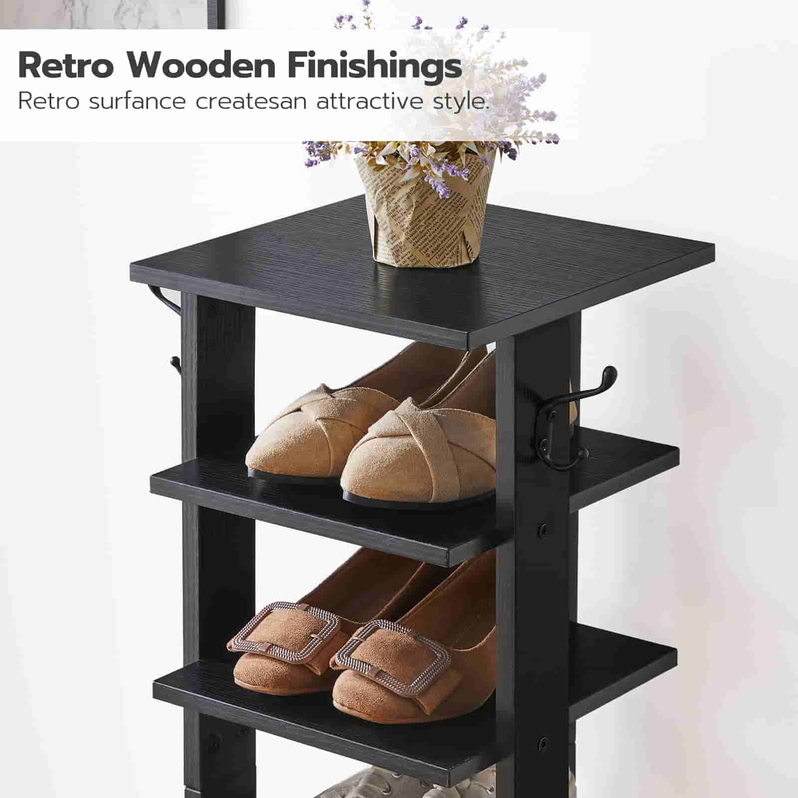 Black shoe rack with retro wooden finish holding shoes and a vase on a white background