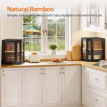 Two black-framed bamboo wood display cabinets with glass doors shown in a bright, modern kitchen setting. The cabinets are styled on a wooden countertop next to a window, with a toaster, bread, and decorative items nearby.