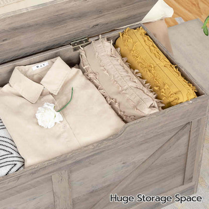 Wooden storage box with clothes and pillows labeled 'Huge Storage Space'.