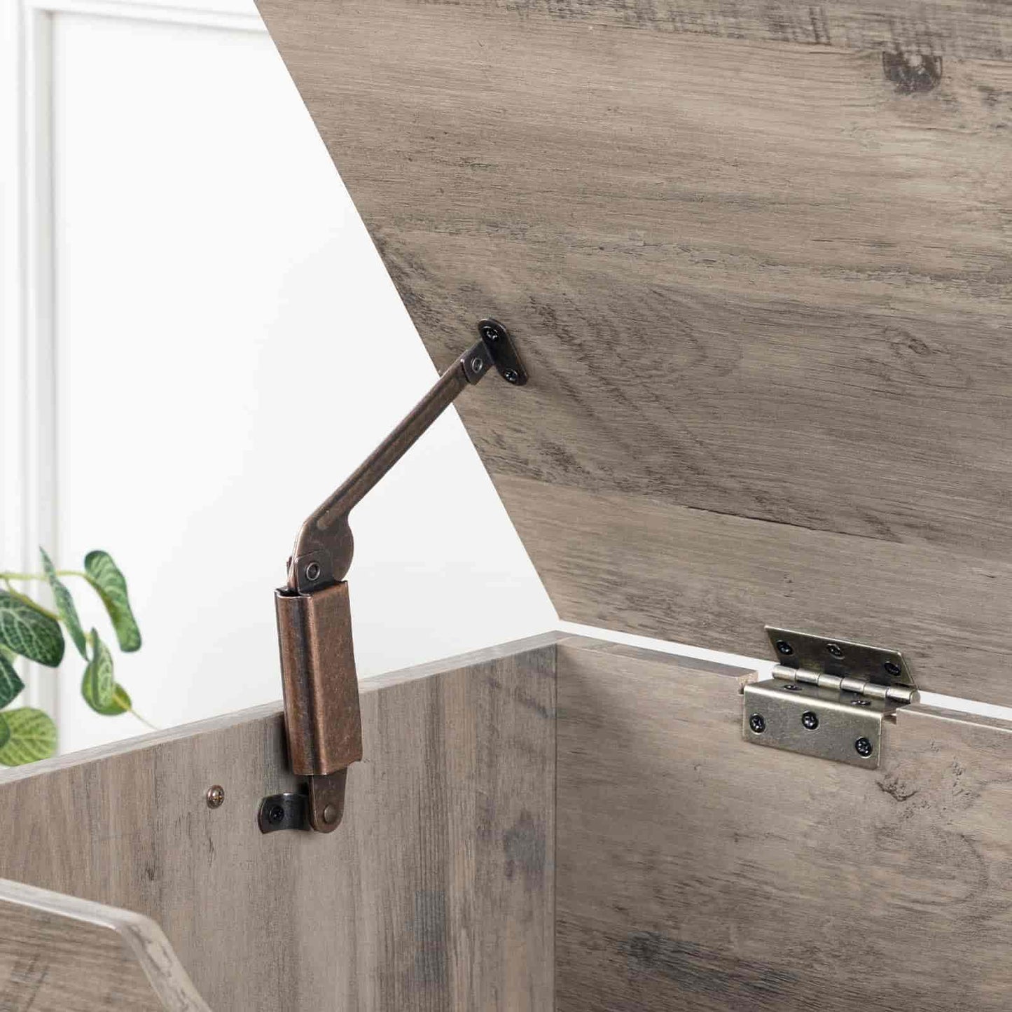 Wooden panel with a metal bracket and hinge on a white background
