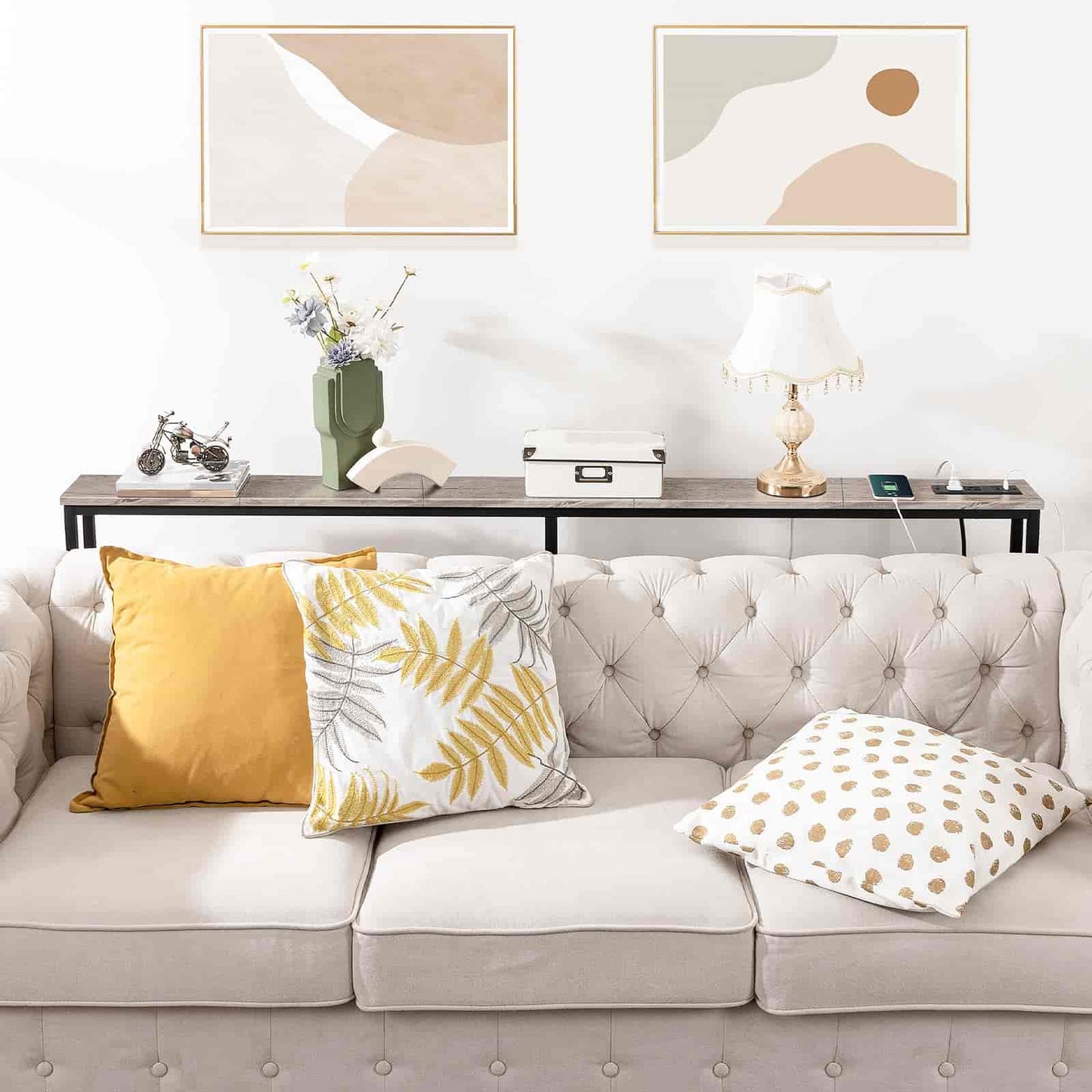 Living room with a gray sofa, decorative pillows, and abstract art on the wall.