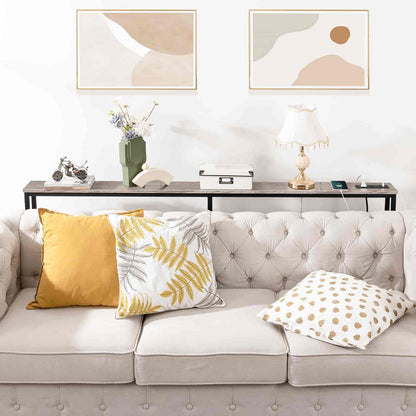 Living room with a gray sofa, decorative pillows, and abstract art on the wall.