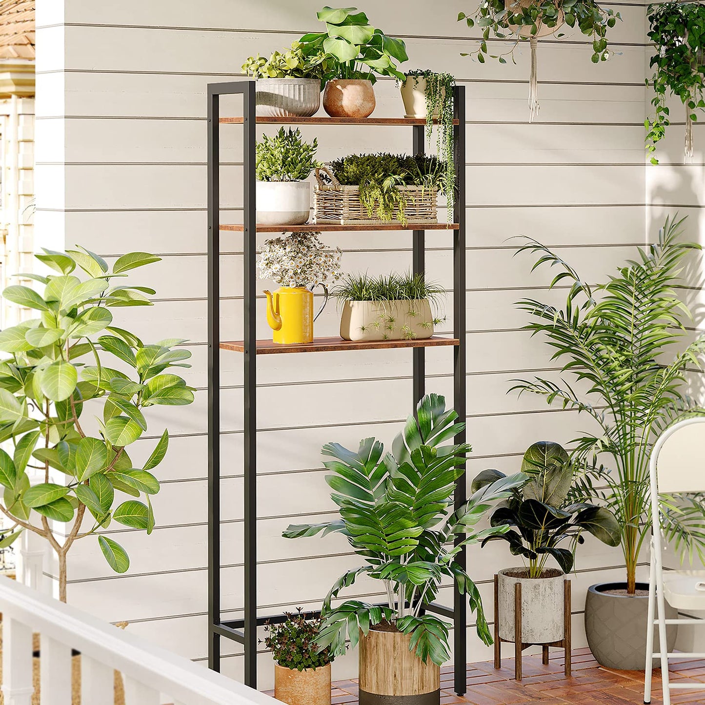 Tall metal shelving unit with plants on a wooden deck