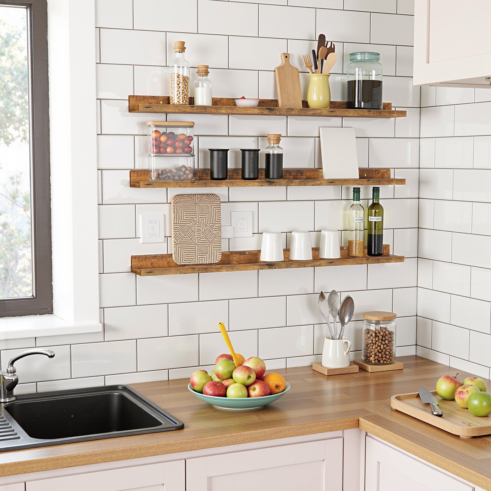 Kitchen with wooden shelves, fruit bowl, and various kitchen items on a tiled wall.