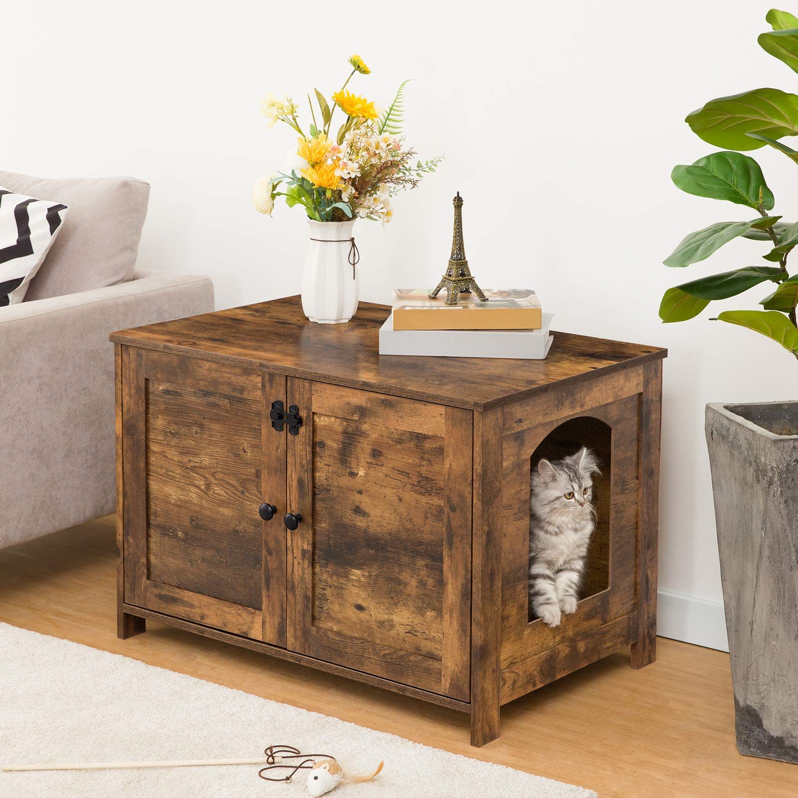 Wooden pet furniture with a cat inside, placed in a living room setting.