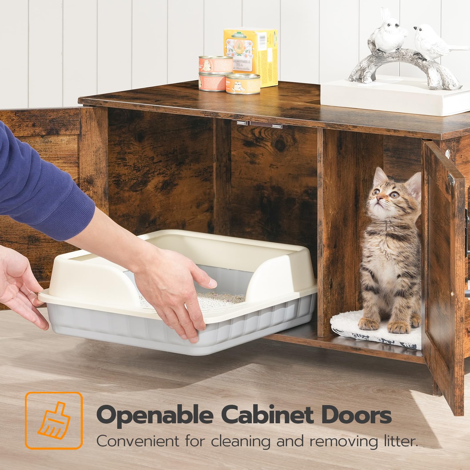 Wooden cabinet with openable doors, cat inside, and person reaching for a litter box.