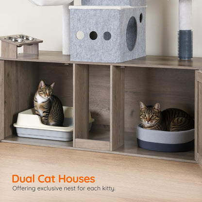 Two cats in a wooden cat house with a litter box and perches.