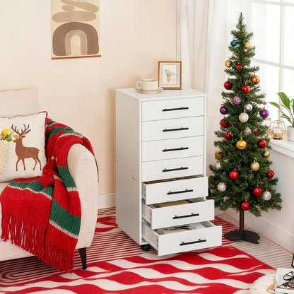 White storage cabinet with drawers next to a decorated Christmas tree in a living room.