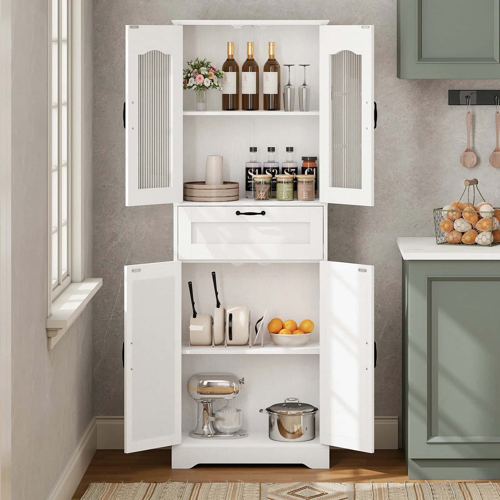 White kitchen cabinet with open doors displaying various kitchen items against a neutral wall.