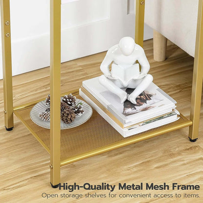 Gold metal mesh shelf with books, decorative items, and a sculpture on a wooden floor.