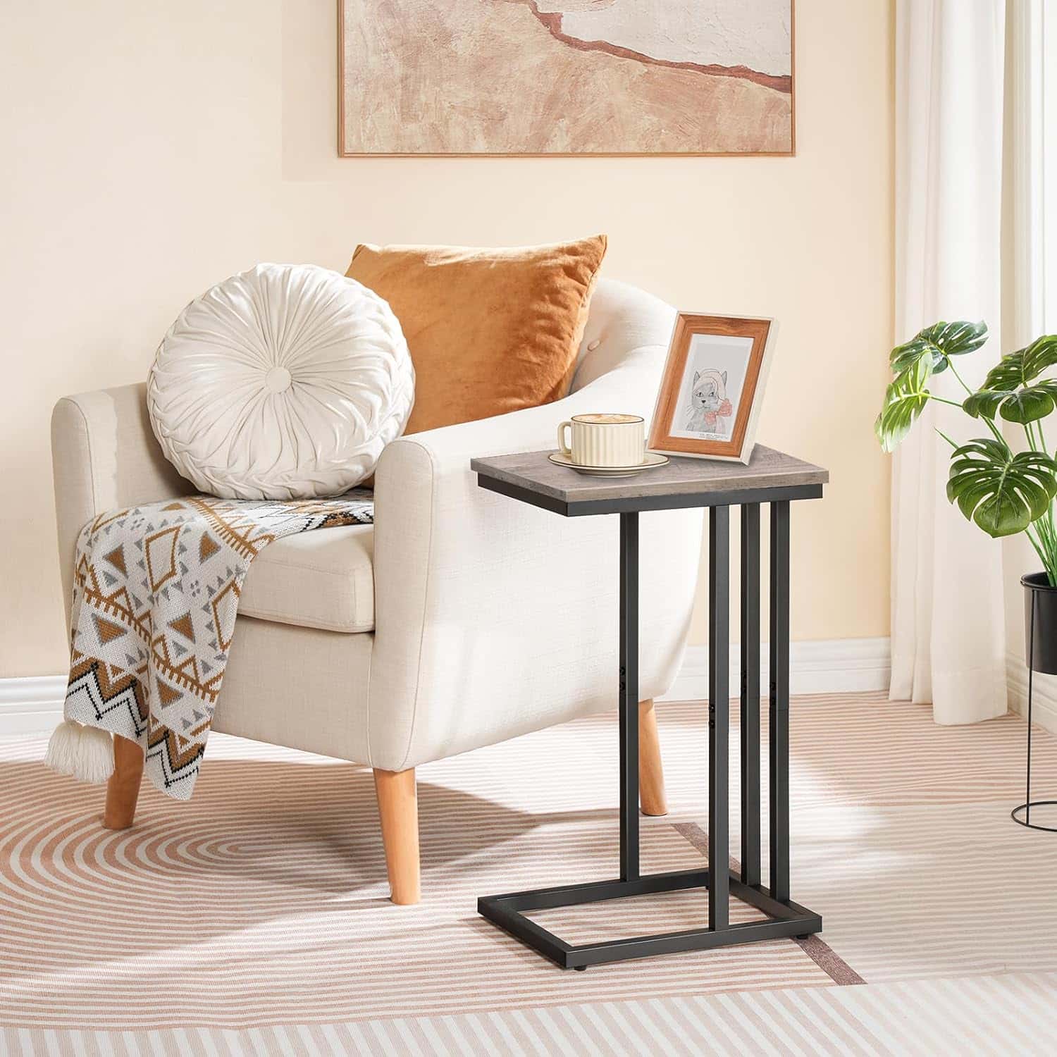 White armchair with cushions and a small table in a living room setting